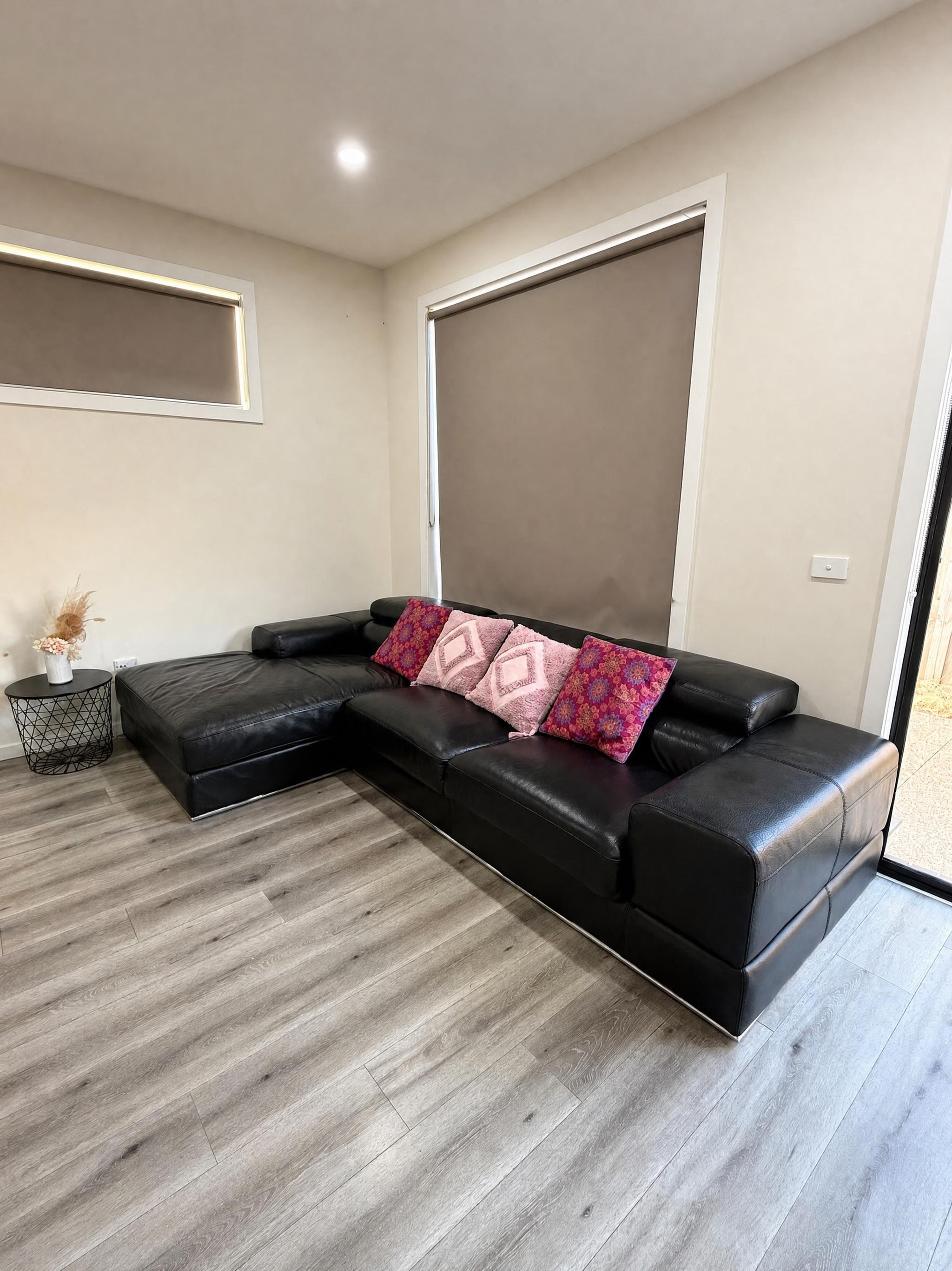 Lounge with black corner sofa at Luxe Nest, 33 Maya Avenue