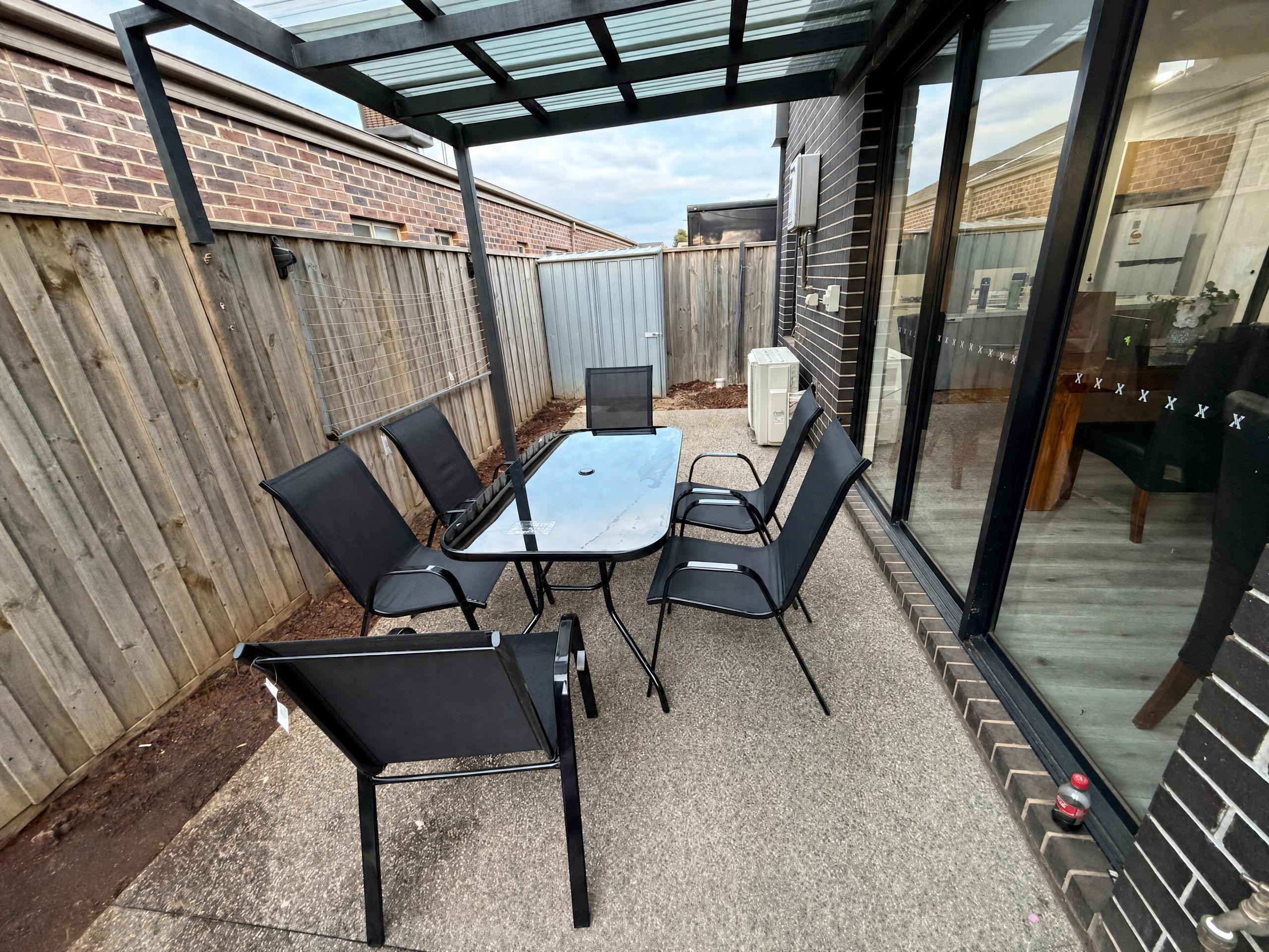 Covered patio with outdoor dining setting at Luxe Nest, 33 Maya Avenue