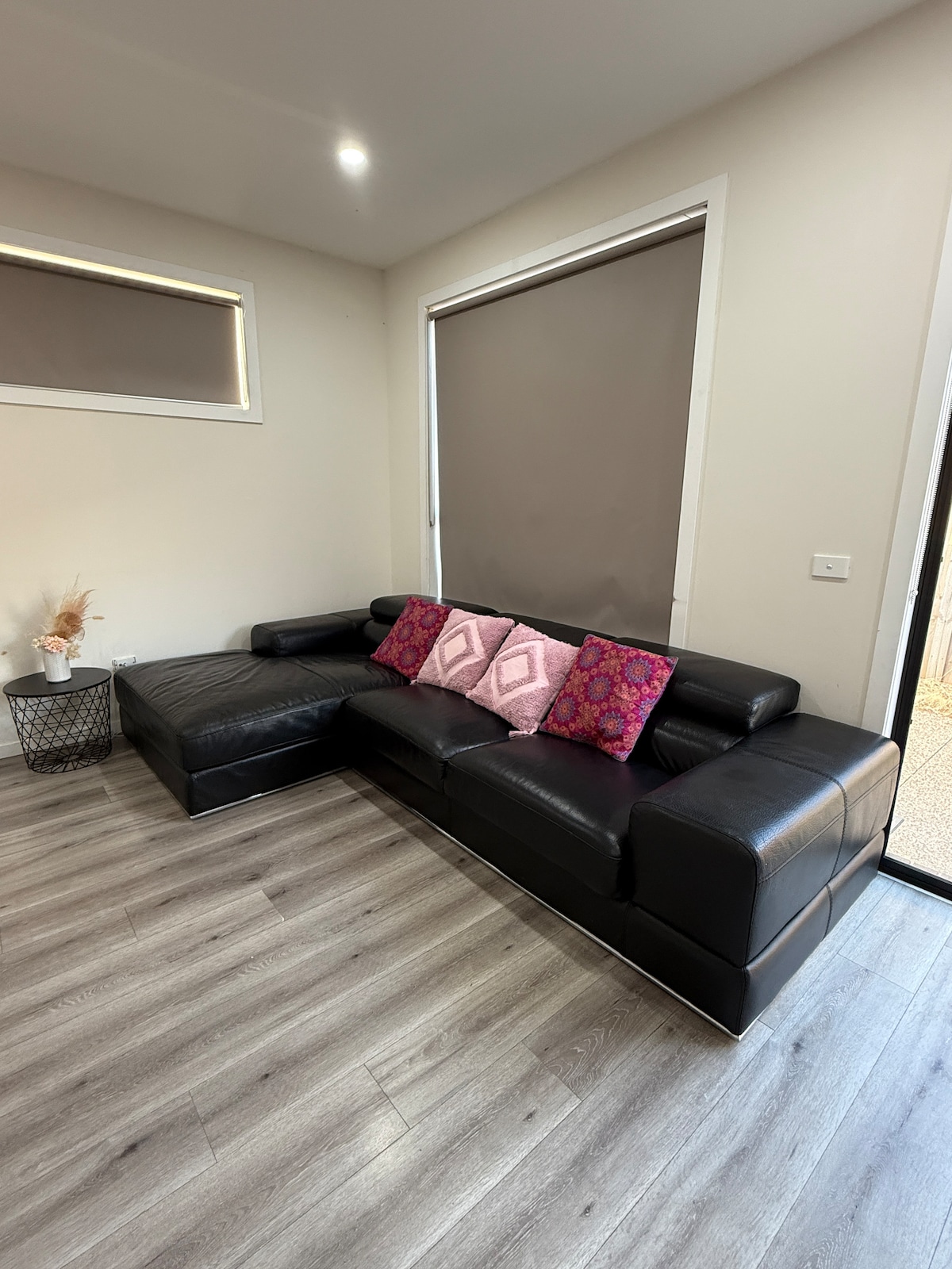 Lounge with black corner sofa at Luxe Nest, 33 Maya Avenue