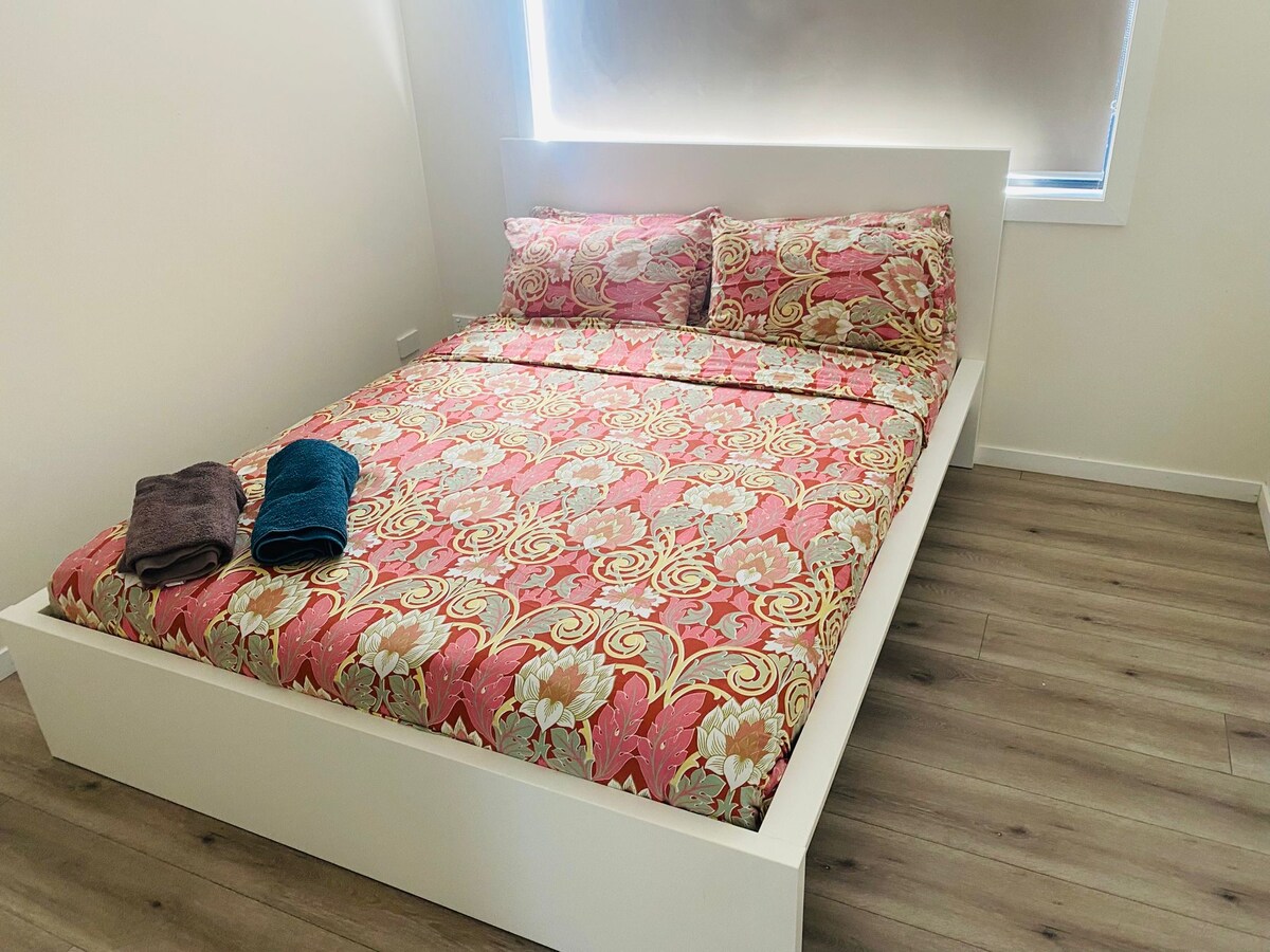 Bedroom with pink quilt at Luxe Nest, 33 Maya Avenue