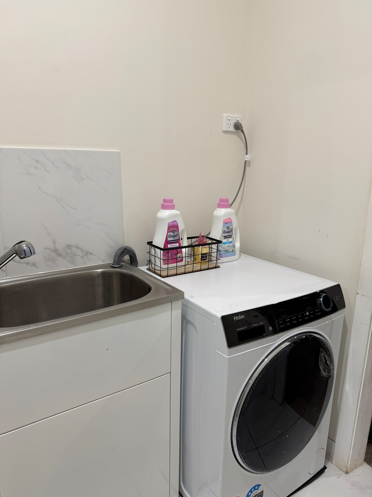 Laundry with washing machine and sink at Luxe Nest, 33 Maya Avenue