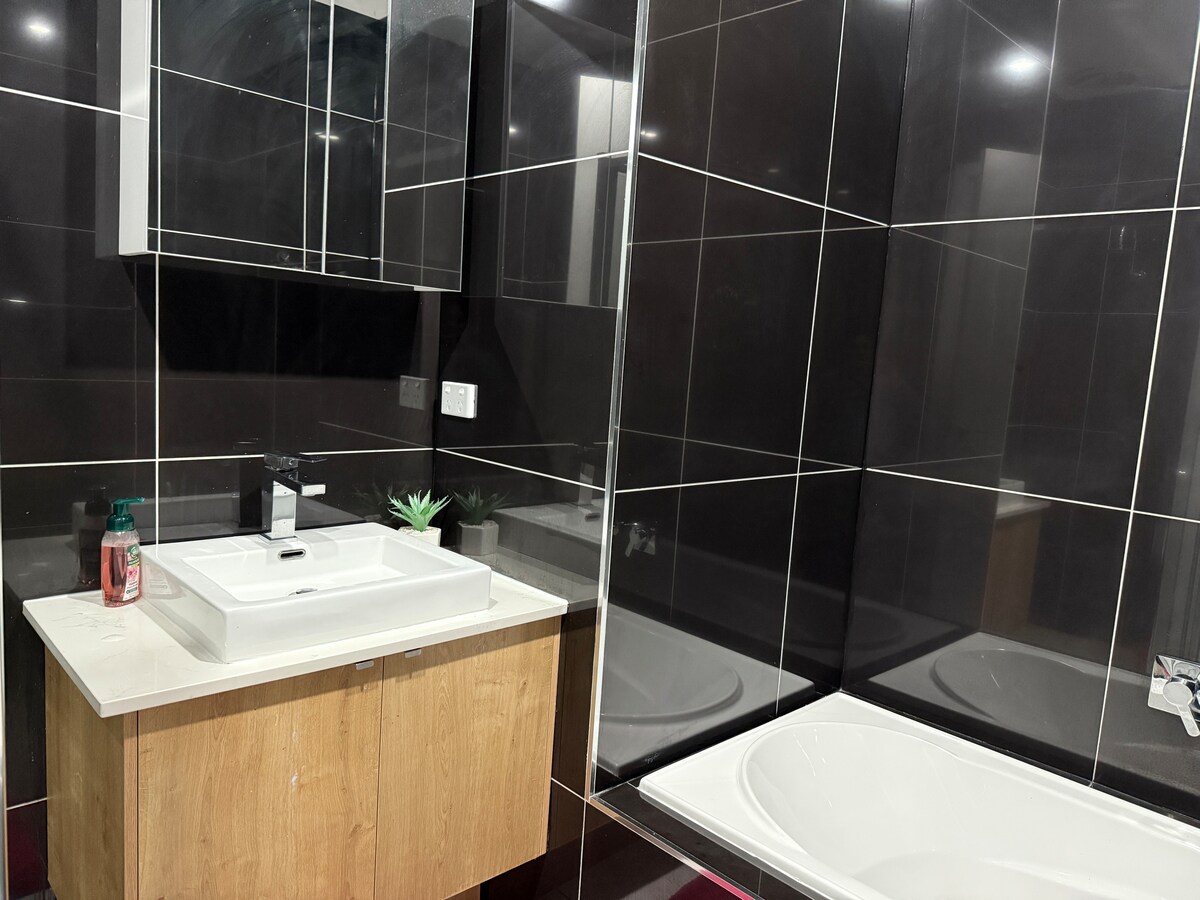 Main bathroom with vanity and bath at Luxe Nest, 33 Maya Avenue