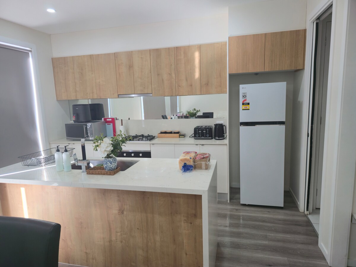 Full kitchen with island bench at Luxe Nest, 33 Maya Avenue