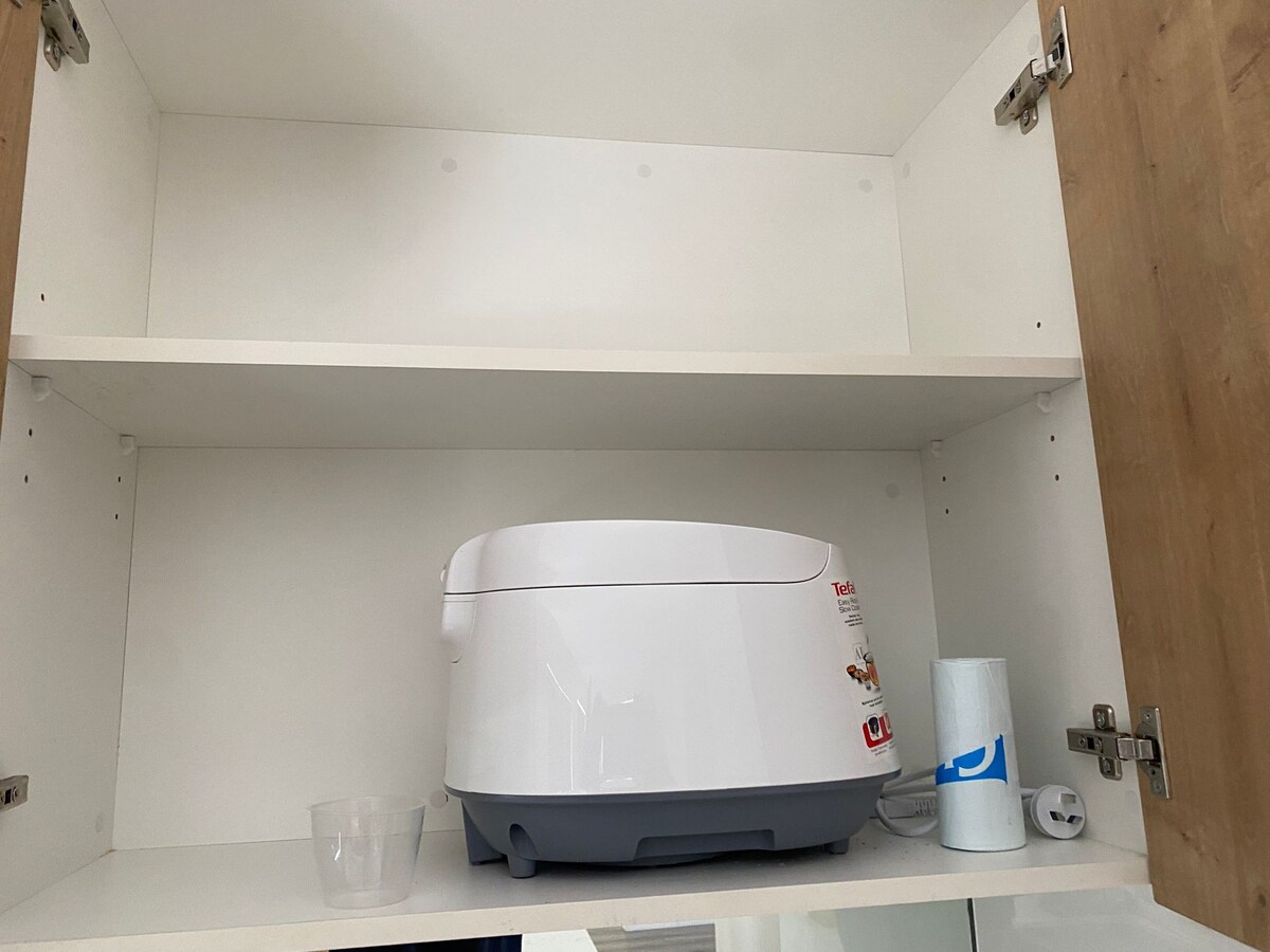 Kitchen cupboard with small appliances at Luxe Nest, 33 Maya Avenue