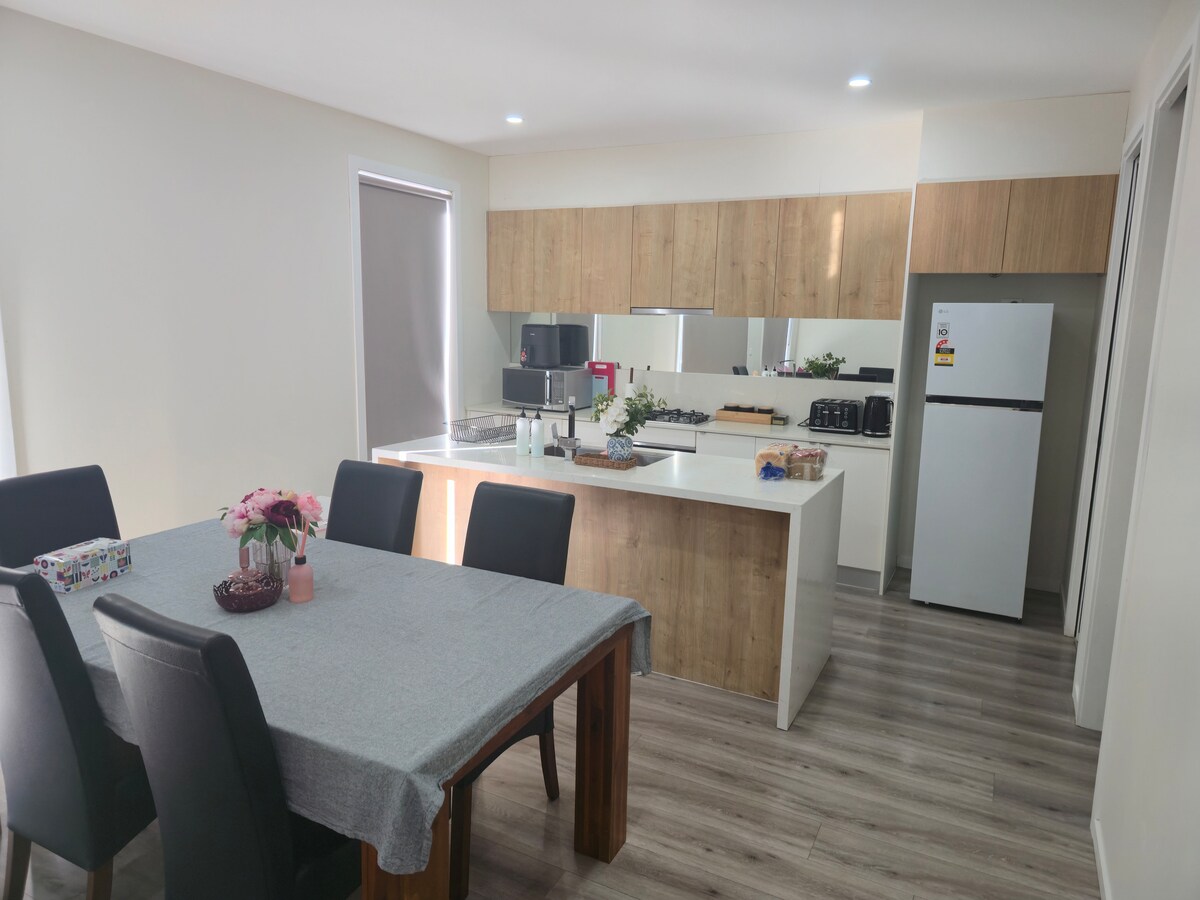 Dining area and open kitchen at Luxe Nest, 33 Maya Avenue