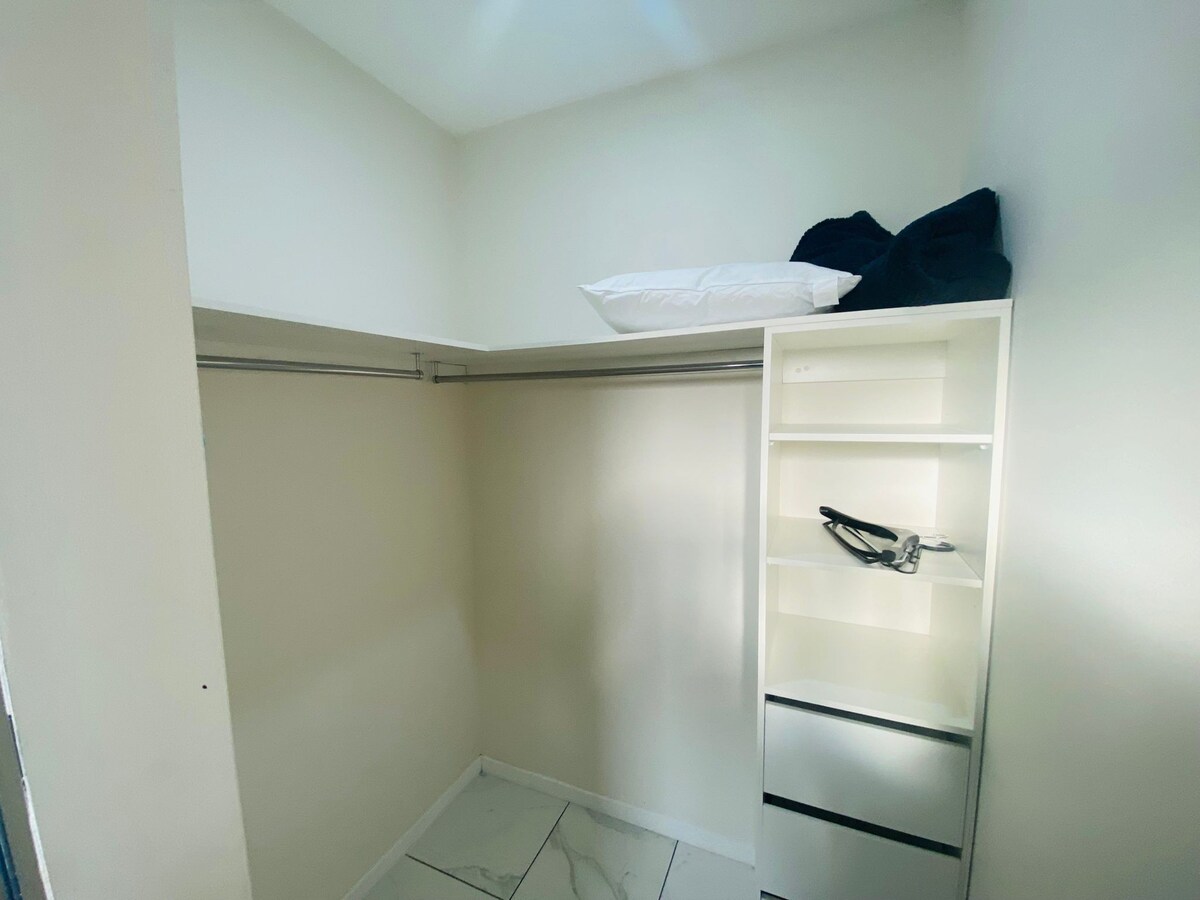 Walk-in wardrobe with shelving at Luxe Nest, 33 Maya Avenue