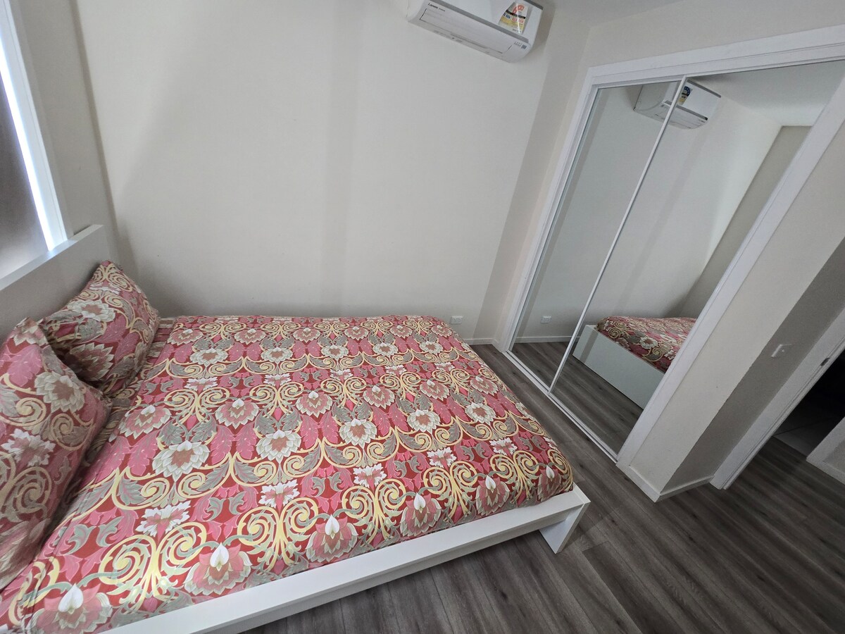 Bedroom with pink quilt at Luxe Nest, 33 Maya Avenue