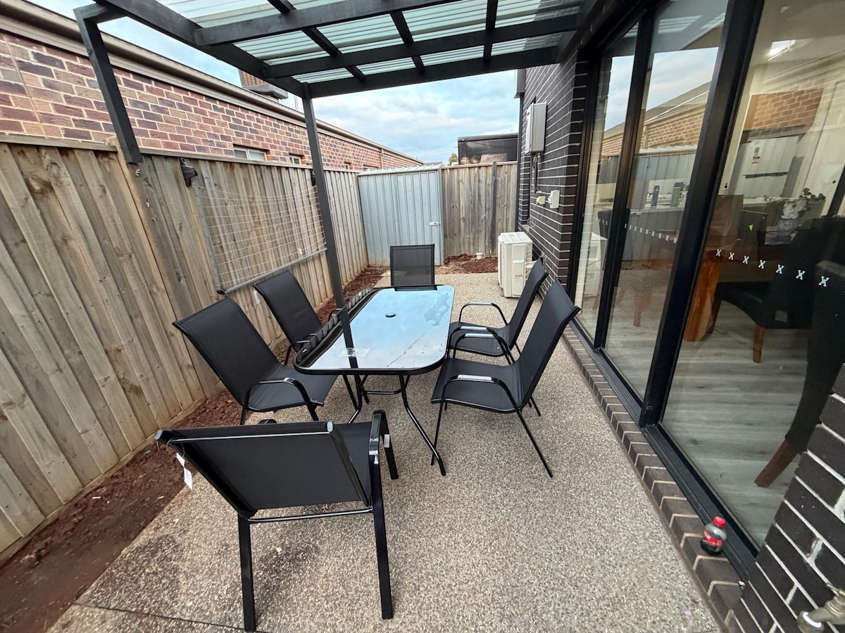 Covered patio with outdoor dining setting at Luxe Nest, 33 Maya Avenue