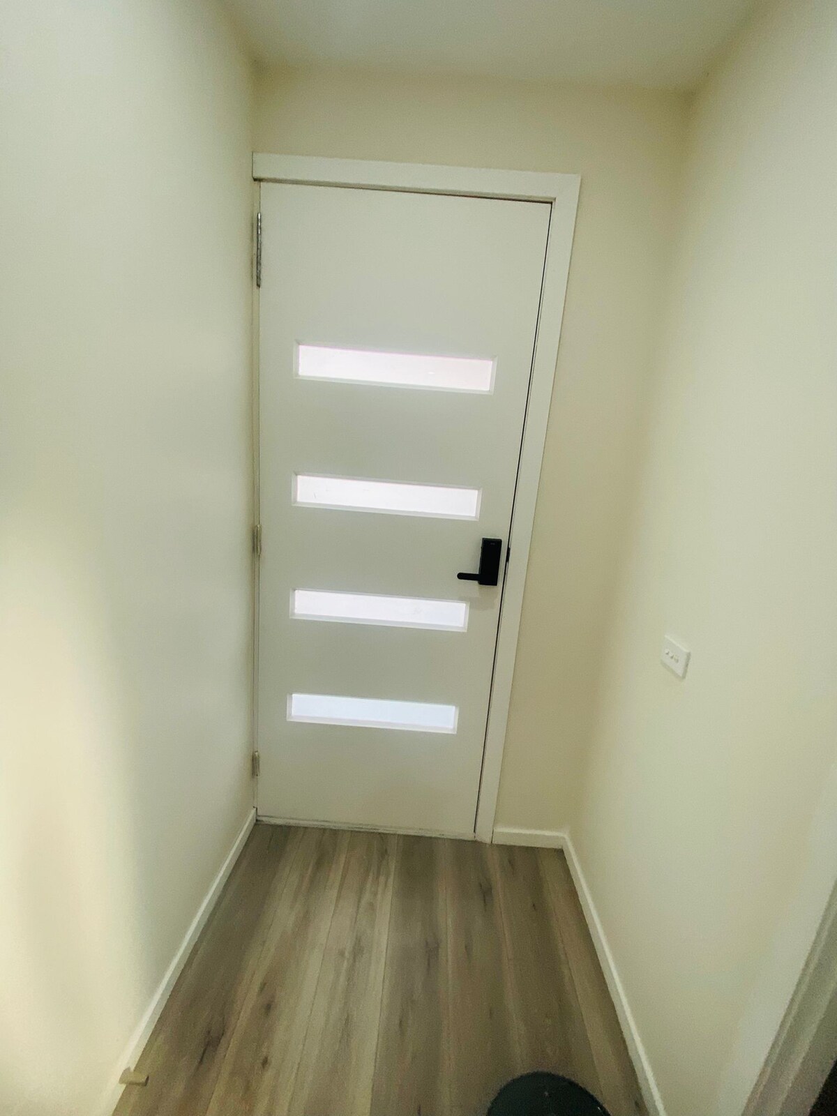 Front door viewed from the entrance hall at Luxe Nest, 33 Maya Avenue