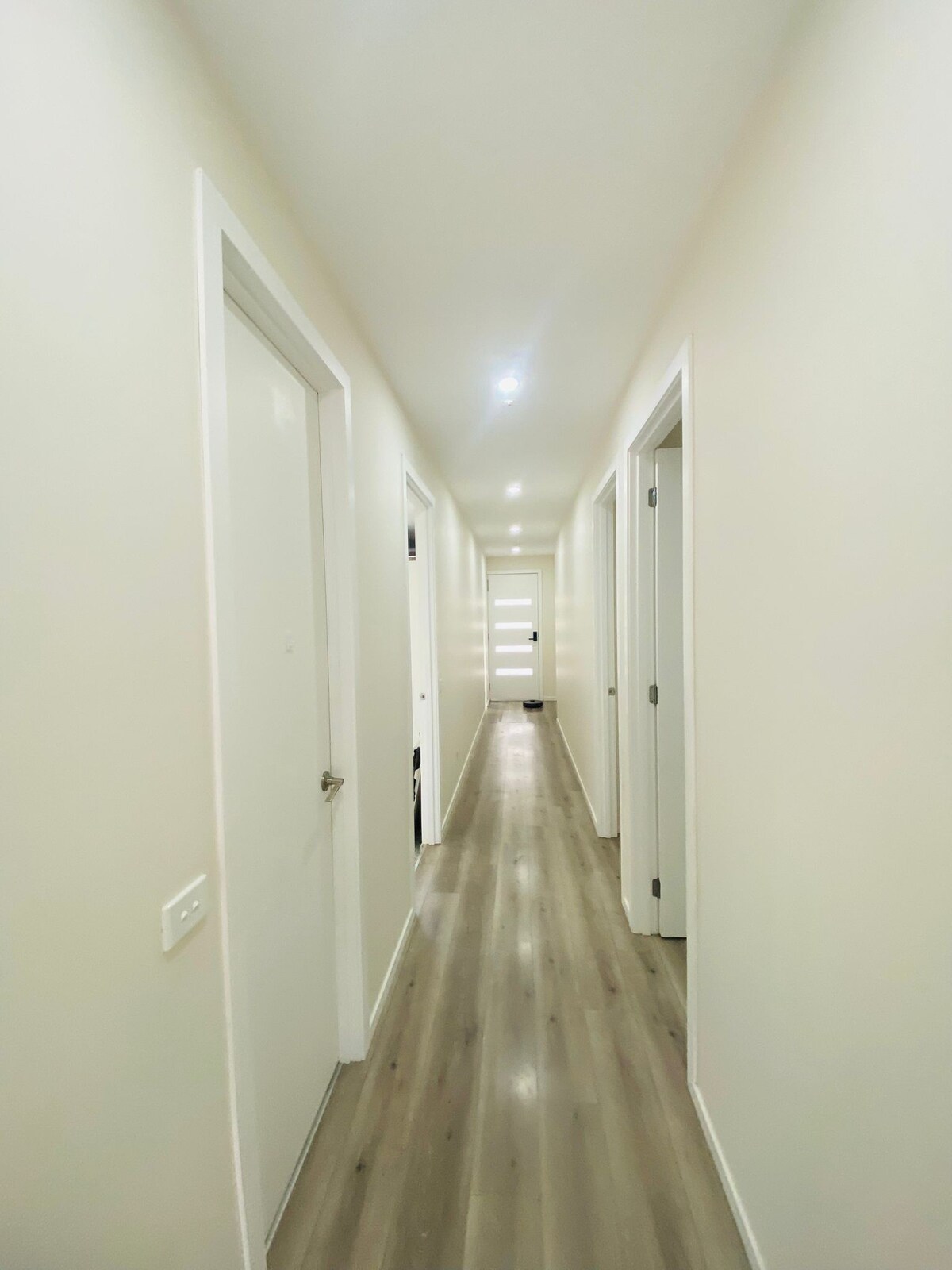 Central hallway with bedroom doors at Luxe Nest, 33 Maya Avenue